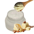 Jar of cream with a wooden spoon, cheese, and nuts on a white background